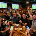 Fans placing bets using the 7m-7m sports betting app while watching live football matches